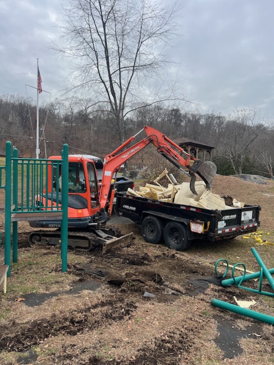 Excavator loading debris during land clearing in Garrison NY